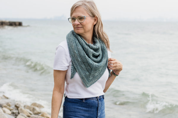 designer wearing handknit shawl from a knitting pattern