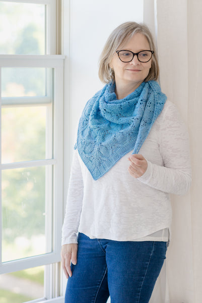 Handknit lace shawl on knitter