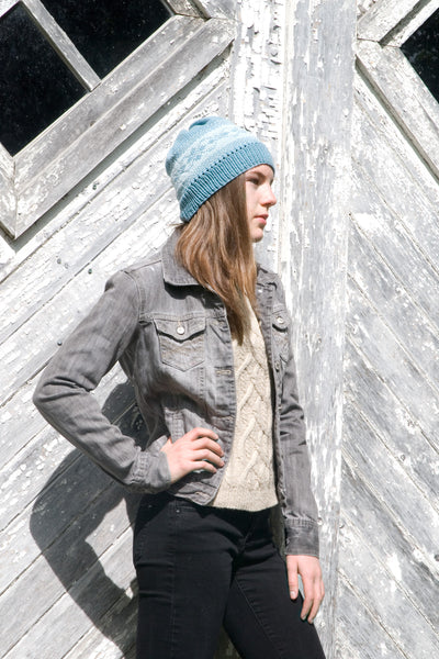 girl modelling hand knit hat pattern