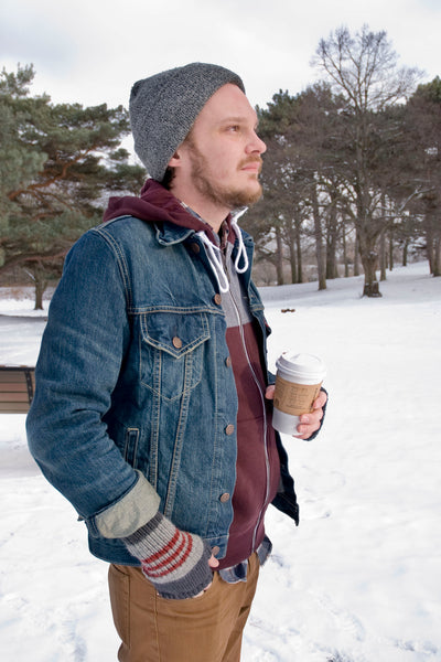 male modelling fhand knit ingerless mitts and having coffee