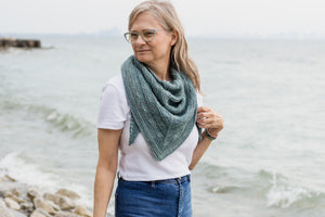 designer wearing handknit shawl from a knitting pattern