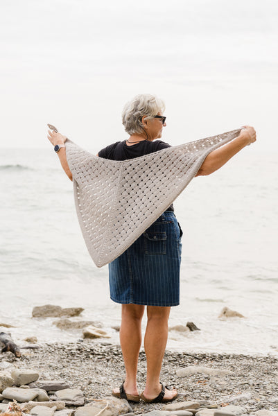 woman showing handknit shawl